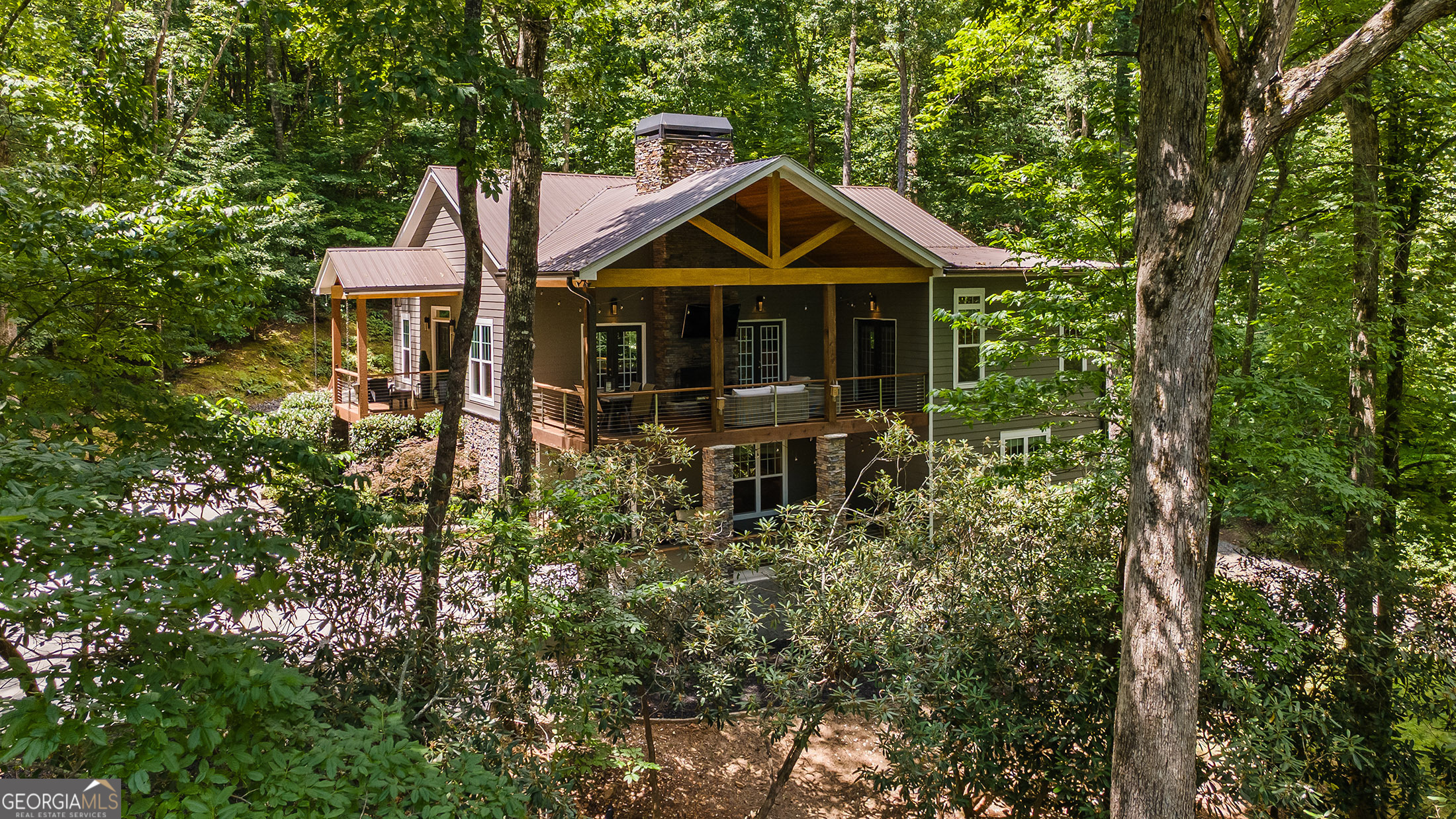 a front view of a house with yard and trees