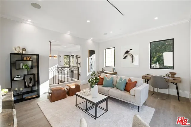 a spacious bedroom with a bed a couch and large window