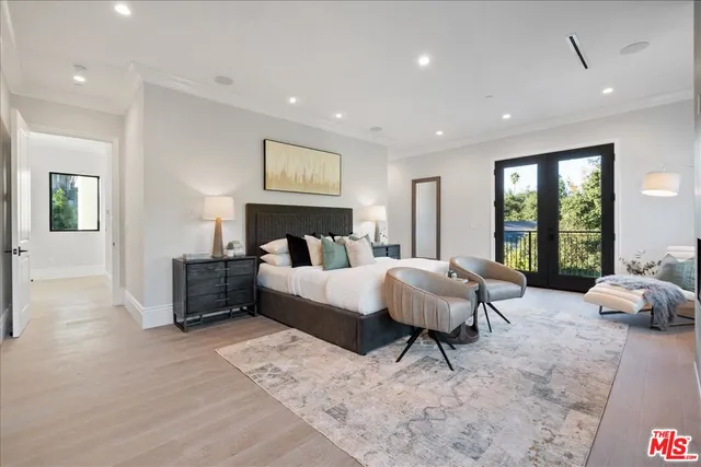 a bedroom with a large bed and a potted plant