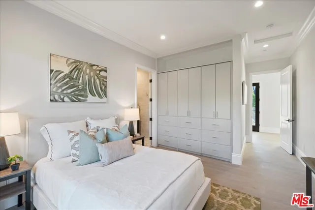 a living room with furniture a flat screen tv and a potted plant