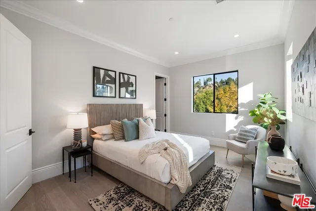 a front view of a house with porch and furniture