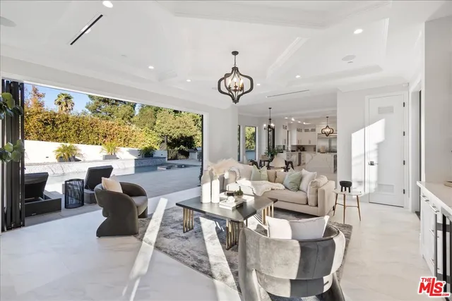 a view of a house with pool fire pit a patio and a garden