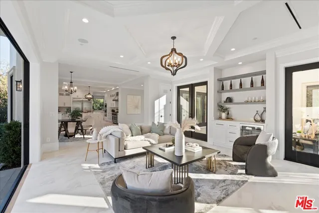 a large white kitchen with lots of counter space wooden floor and appliances