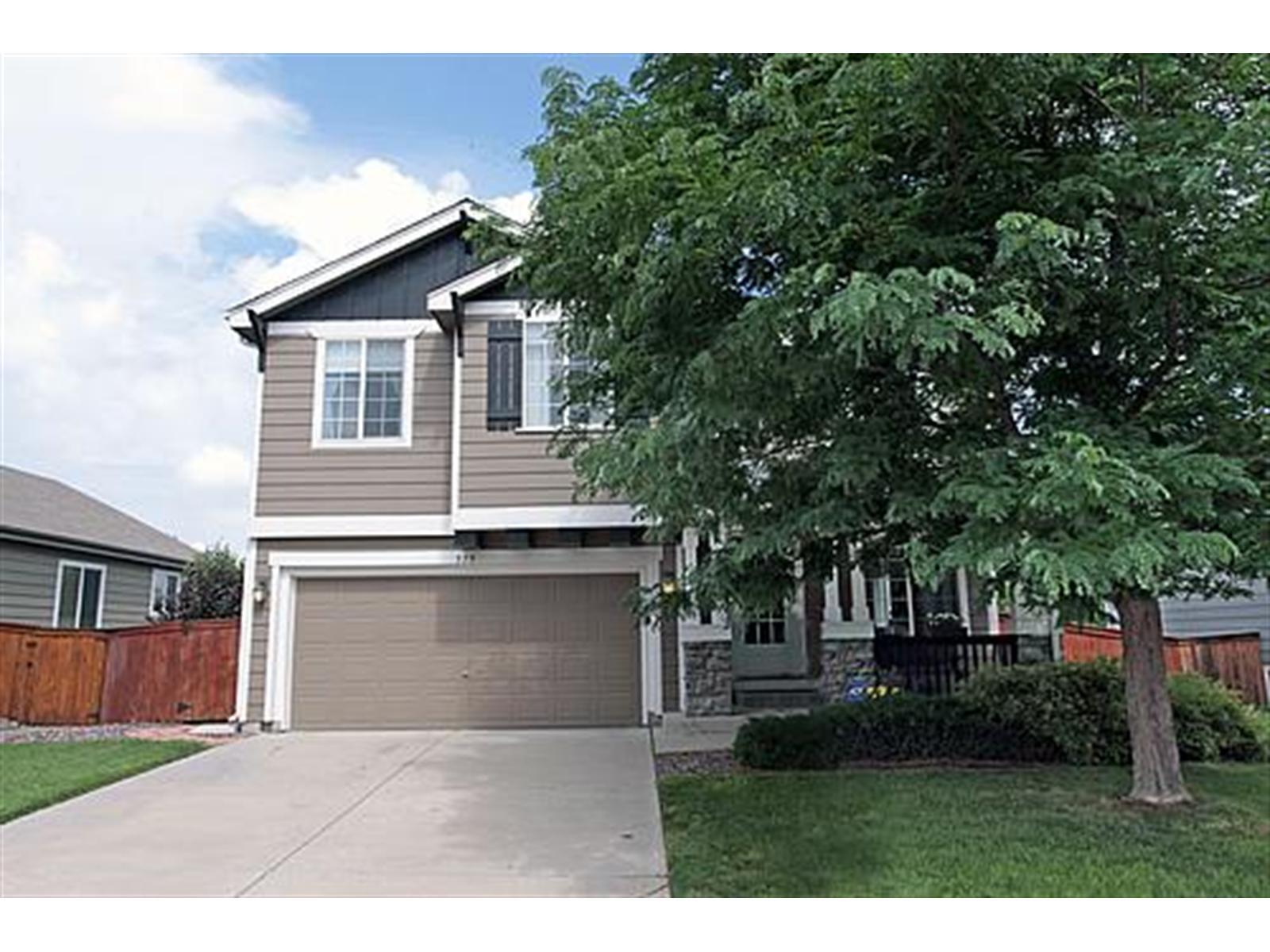 579 Timbervale Trail Highlands Ranch, CO 80129 - Photo 1 of 1 a front view of a house with a garden and trees