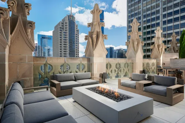 a view of a patio with couches and a potted plant on a table and a fire pit