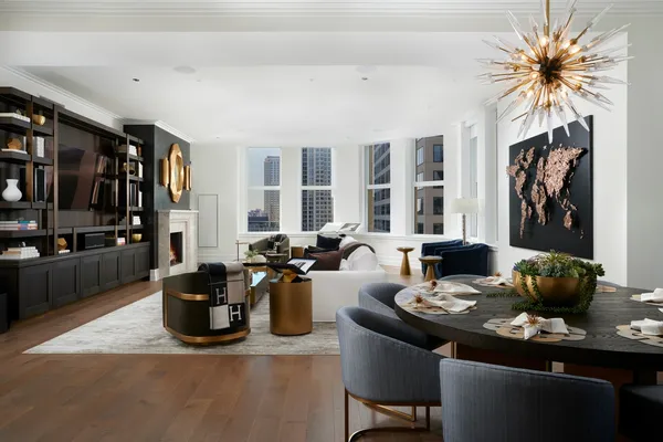 a living room with furniture a bookshelf and a fireplace