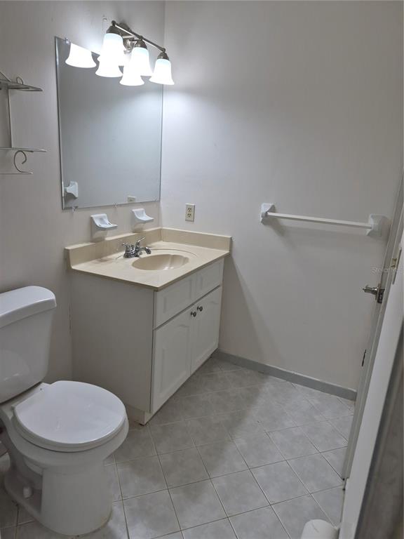 25632 Southwest 19 Avenue Newberry, FL 32669 - Photo 15 of 20 a bathroom with a sink a toilet and a mirror