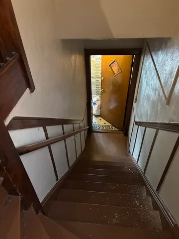 a view of staircase with wooden floor and a floor to ceiling window