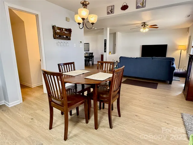 a view of a dining room with furniture and chandelier