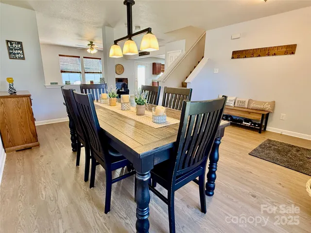 a view of a dining room with furniture and a chandelier