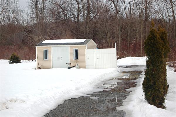 1047 Great Road Lincoln, RI 02865 - Photo 16 of 17 a view of a house with a yard covered in snow