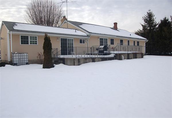 1047 Great Road Lincoln, RI 02865 - Photo 17 of 17 a front view of a house with a yard covered in snow