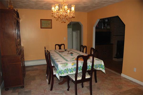 1047 Great Road Lincoln, RI 02865 - Photo 8 of 17 a dining room with furniture and chandelier