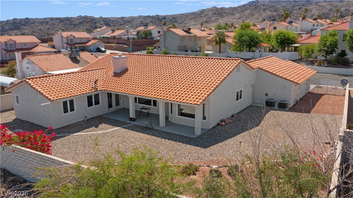 2055 Cholla Way Laughlin, NV 89029 - Photo 73 of 87 A spacious desert-adapted yard offers low maintenance and a vibrant natural backdrop for this single-level home.