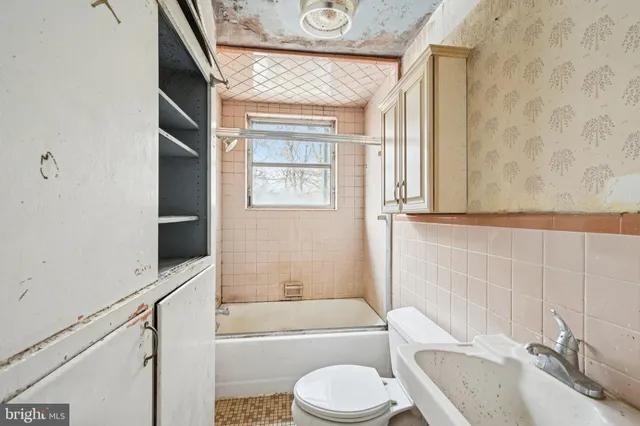 a bathroom with a granite countertop toilet sink and bathtub