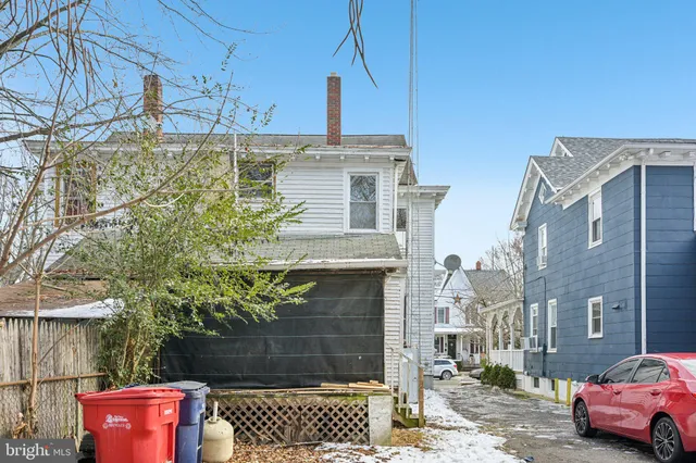 a view of a house with a large tree in front of a house
