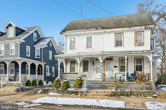 a front view of a residential apartment building with a yard