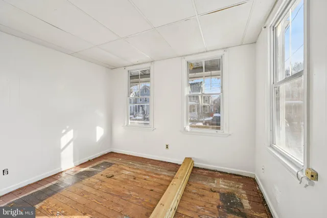 a view of a livingroom with wooden floor and a window