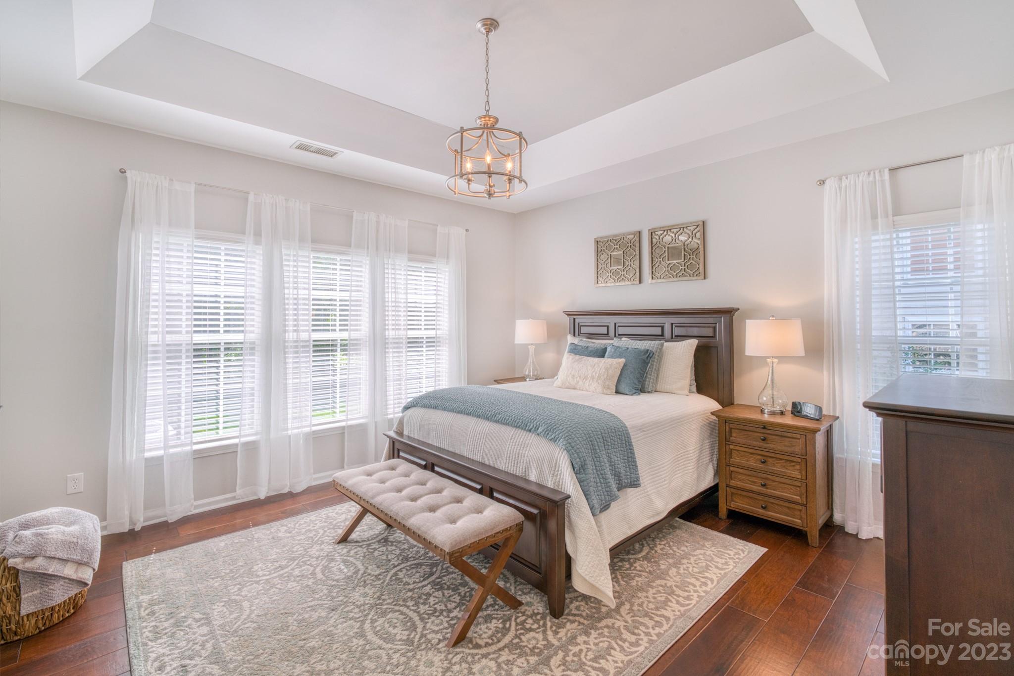 16022 Lavenham Road Huntersville, NC 28078 - Photo 16 of 35 a spacious bedroom with a bed and wooden floor