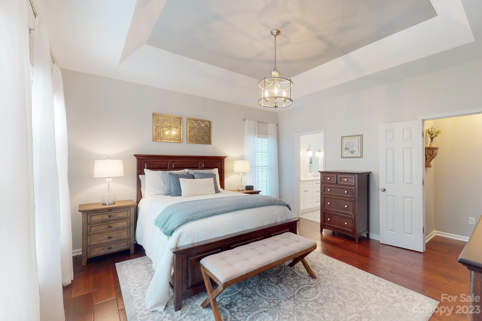16022 Lavenham Road Huntersville, NC 28078 - Photo 17 of 35 a bedroom with a bed and a chandelier