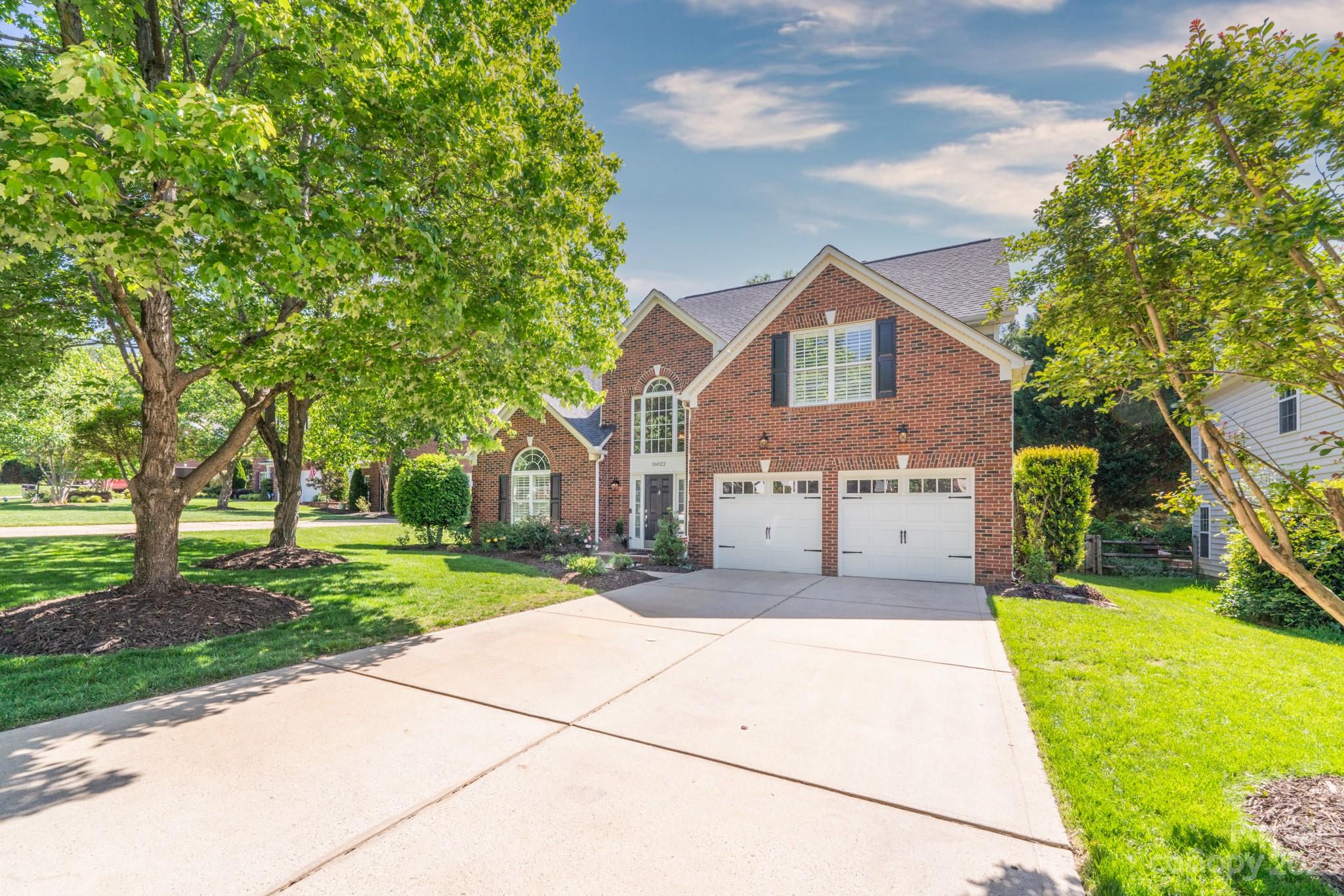 16022 Lavenham Road Huntersville, NC 28078 - Photo 2 of 35 a front view of a house with a yard and trees