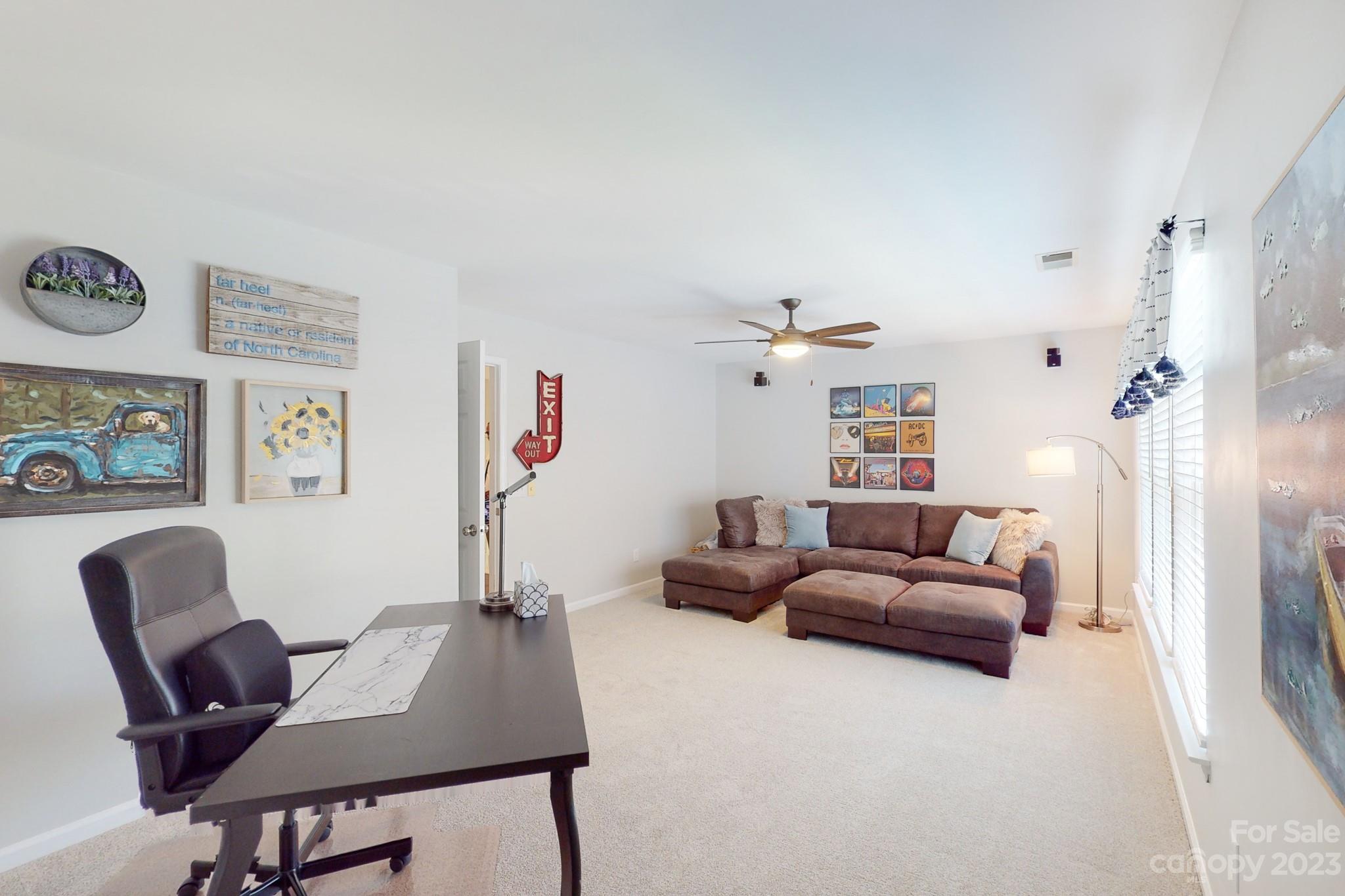16022 Lavenham Road Huntersville, NC 28078 - Photo 24 of 35 a living room with furniture and a flat screen tv