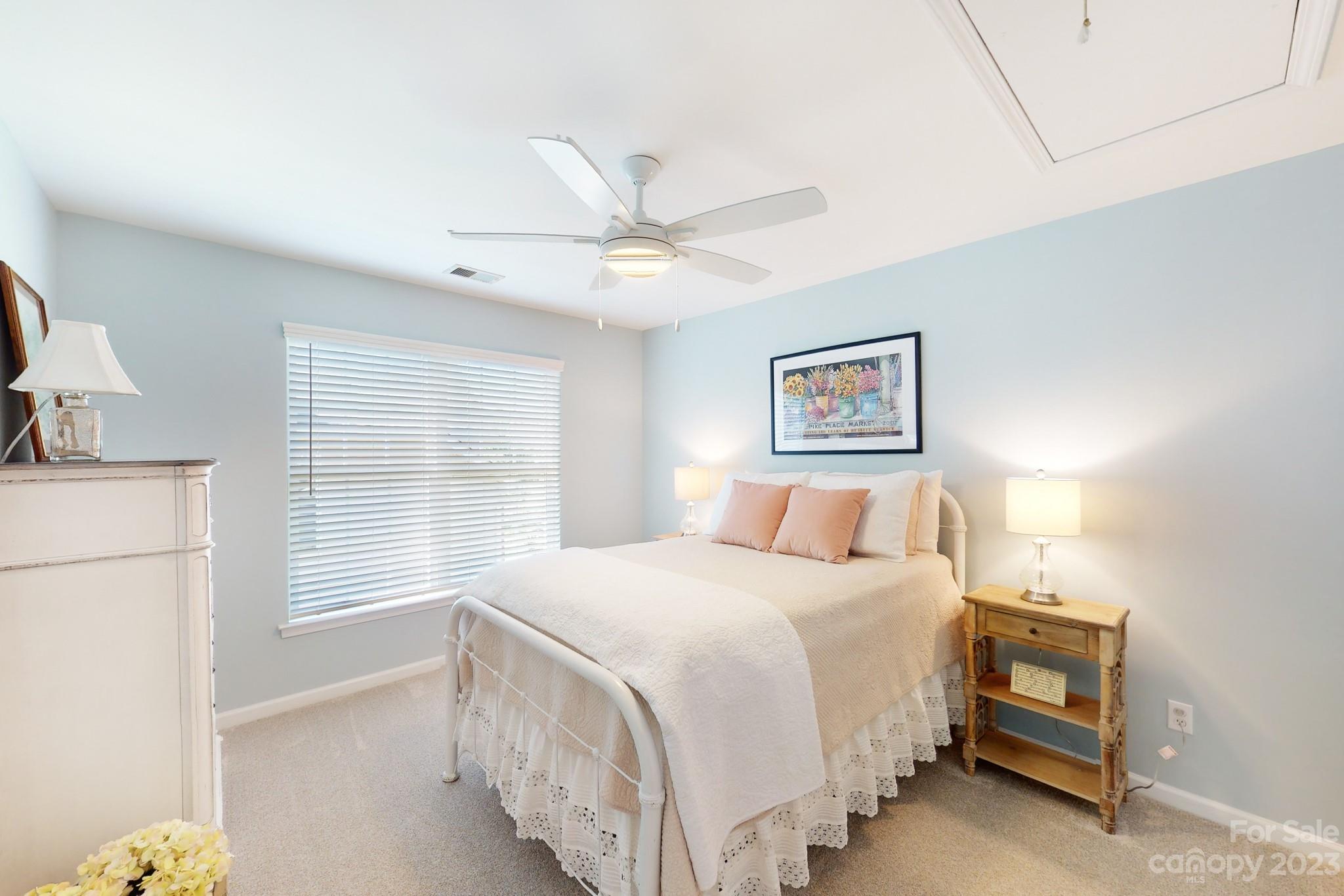 16022 Lavenham Road Huntersville, NC 28078 - Photo 27 of 35 a bedroom with a bed and a chandelier