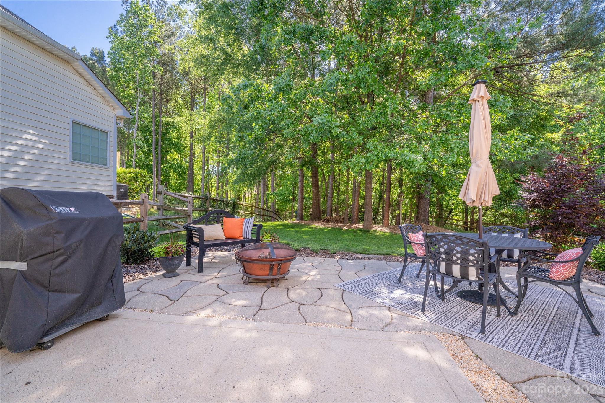16022 Lavenham Road Huntersville, NC 28078 - Photo 33 of 35 a view of a patio with table and chairs potted plants and a large tree
