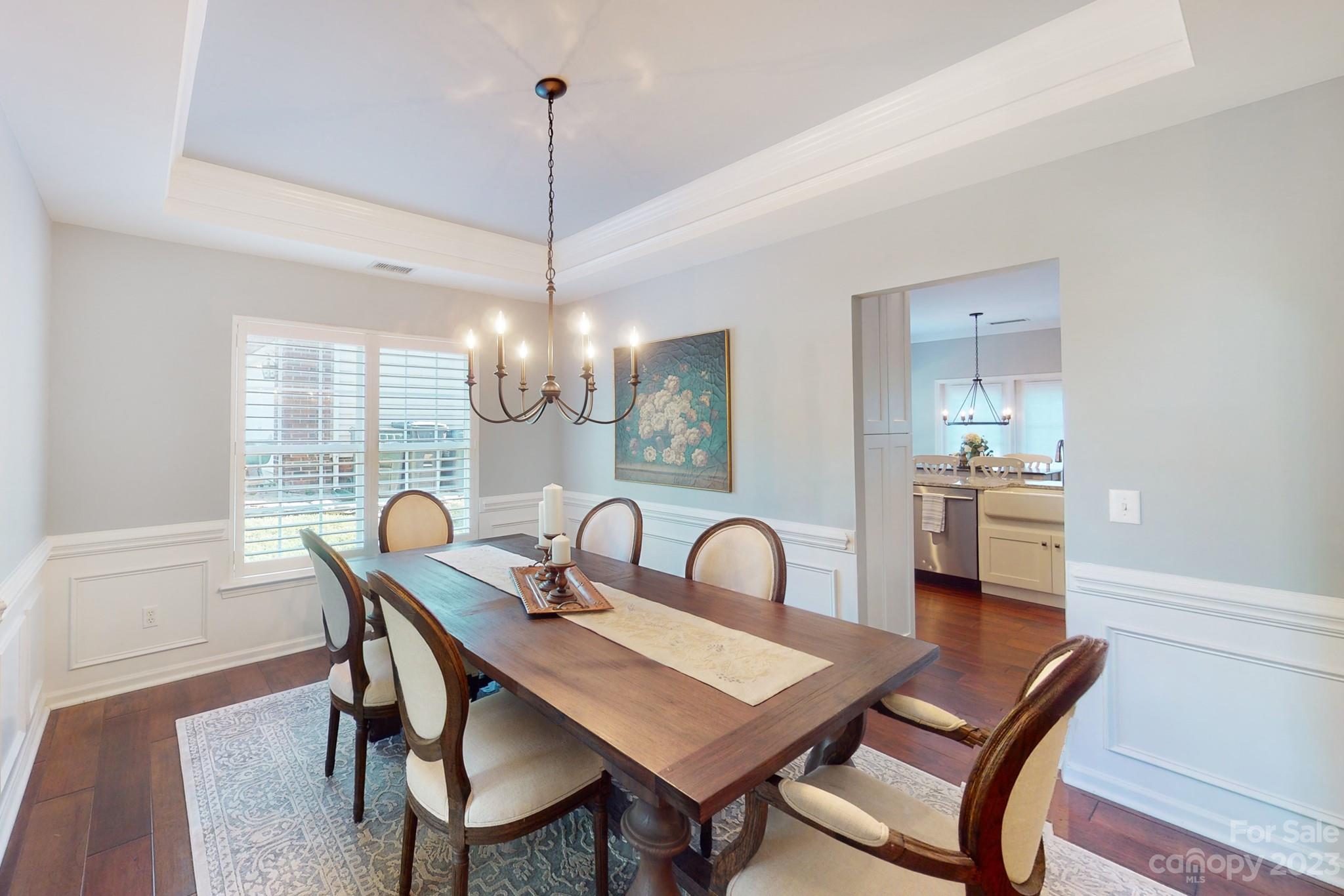 16022 Lavenham Road Huntersville, NC 28078 - Photo 7 of 35 a dining room with furniture a chandelier and wooden floor