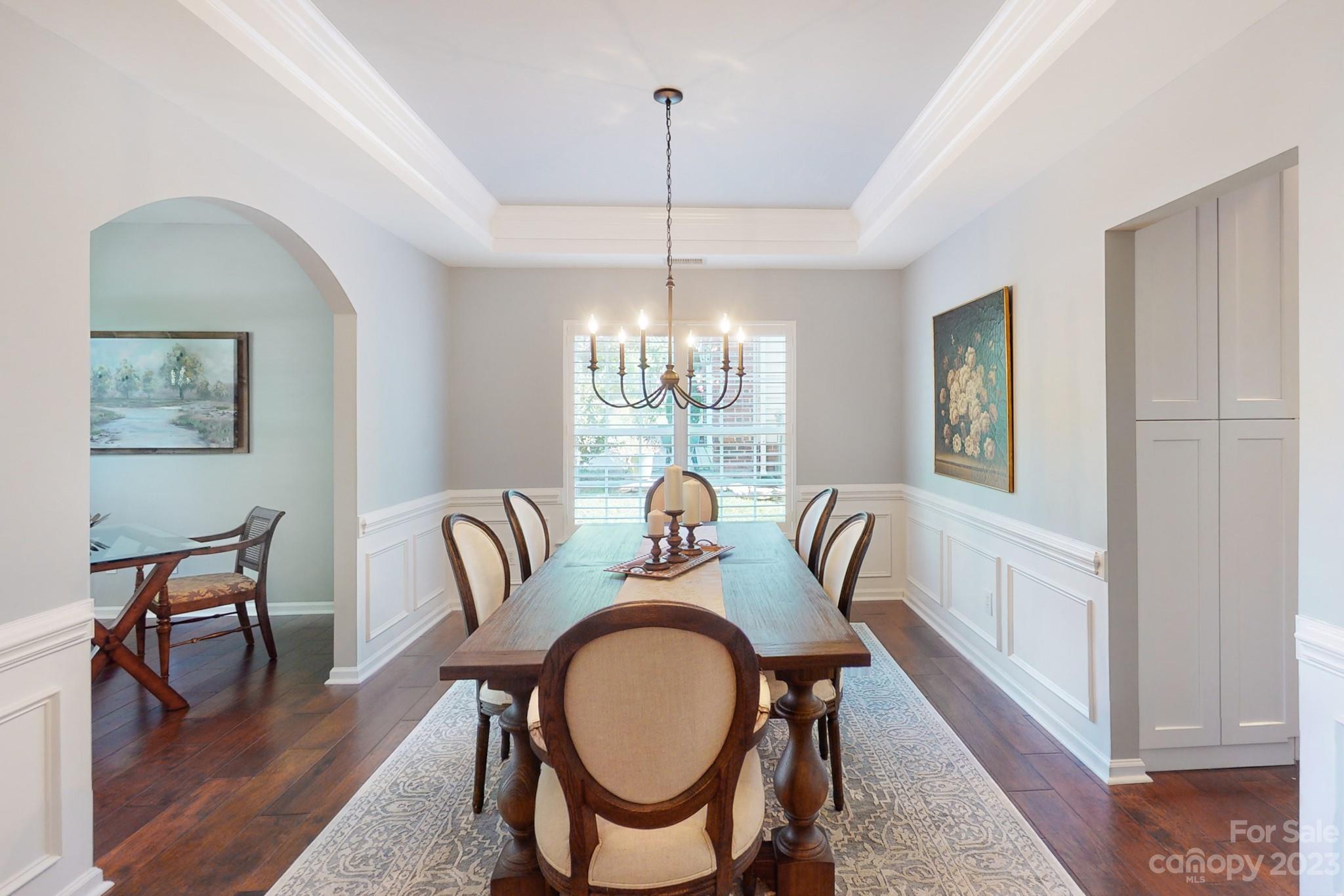 16022 Lavenham Road Huntersville, NC 28078 - Photo 8 of 35 a dining room with furniture a chandelier and wooden floor