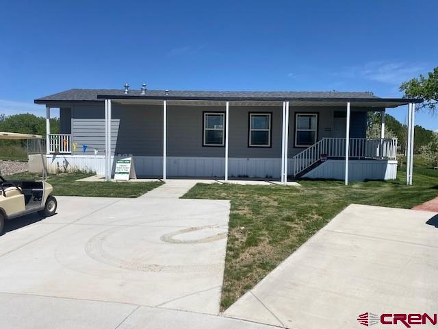 901 6530 Road, Unit 2813 Montrose, CO 81401 - Photo 1 of 23 front view of a house with a yard