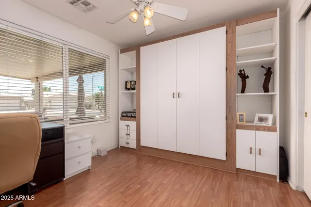 a view of a room with wooden floor and white walls