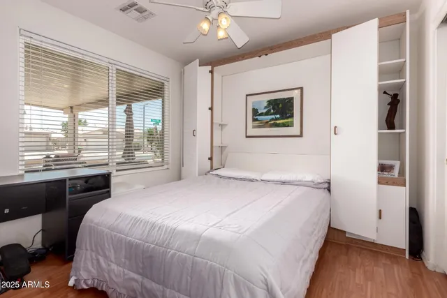 a bedroom with a large bed and a window