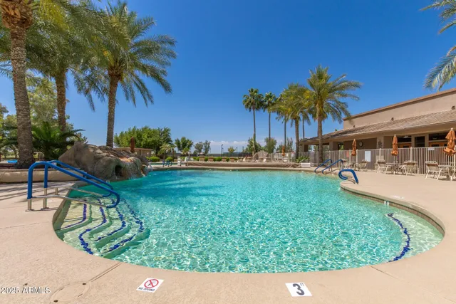 a view of swimming pool with a table and chairs