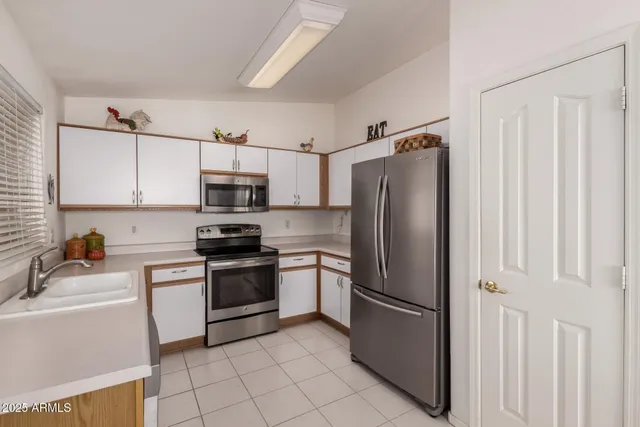 a kitchen with stainless steel appliances a refrigerator sink and microwave