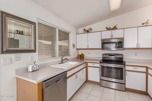 a kitchen with a sink stove and microwave