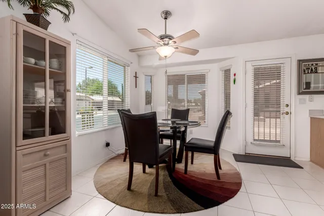 a dining room with furniture a chandelier and wooden floor