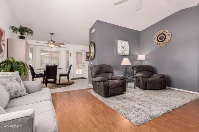 a living room with furniture and wooden floor