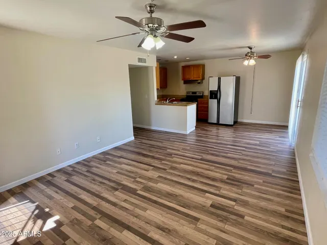 a view of a kitchen with a sink and refrigerator
