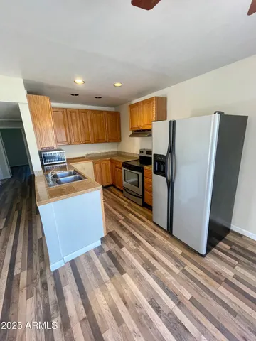 a kitchen with stainless steel appliances a refrigerator and a stove