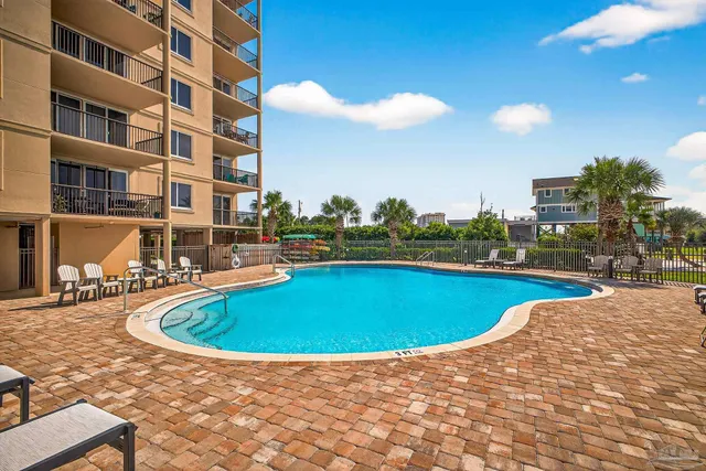 a view of swimming pool with outdoor seating