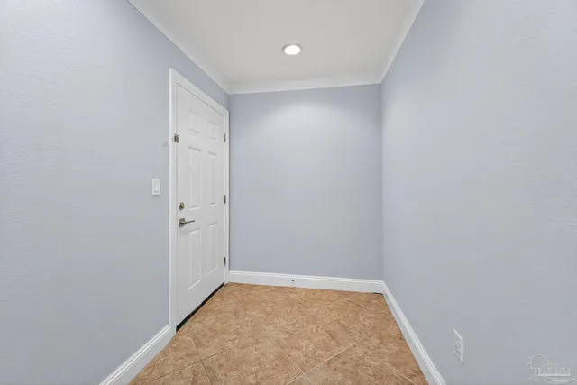 an empty room with windows and ceiling fan view