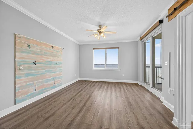 wooden floor chandelier and windows in a room