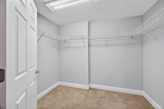 a spacious bathroom with a granite countertop sink and a mirror