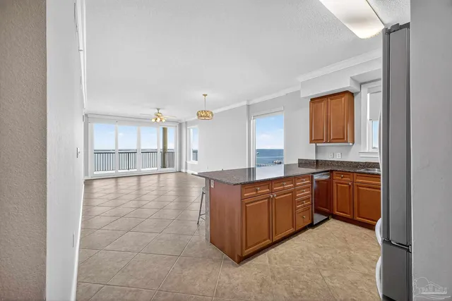 a kitchen with stainless steel appliances granite countertop a refrigerator and a sink