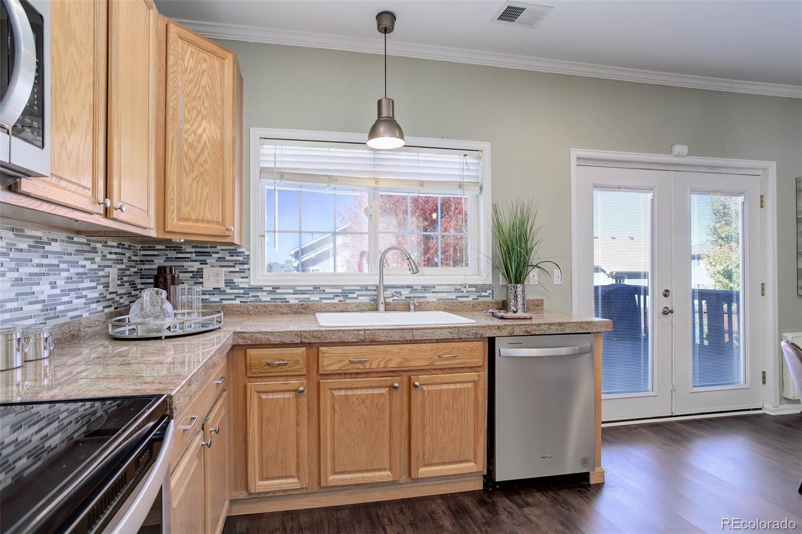 2471 South Andes Circle Aurora, CO 80013 - Photo 11 of 35 a kitchen with stainless steel appliances granite countertop a sink and cabinets