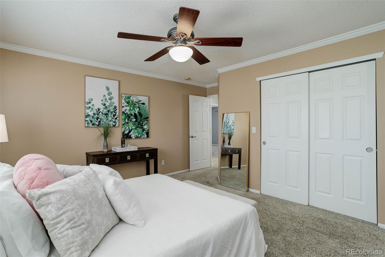 2471 South Andes Circle Aurora, CO 80013 - Photo 19 of 35 a bedroom with a bed and a potted plant