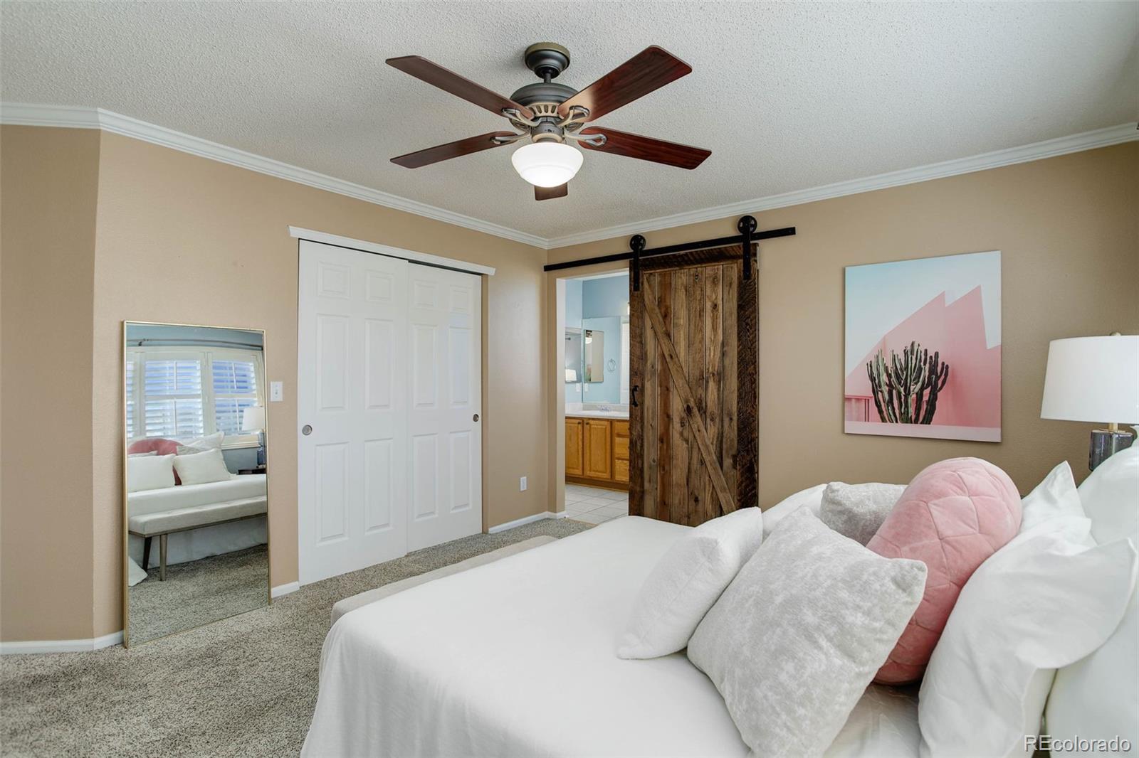2471 South Andes Circle Aurora, CO 80013 - Photo 20 of 35 a bedroom with a large bed and a chandelier
