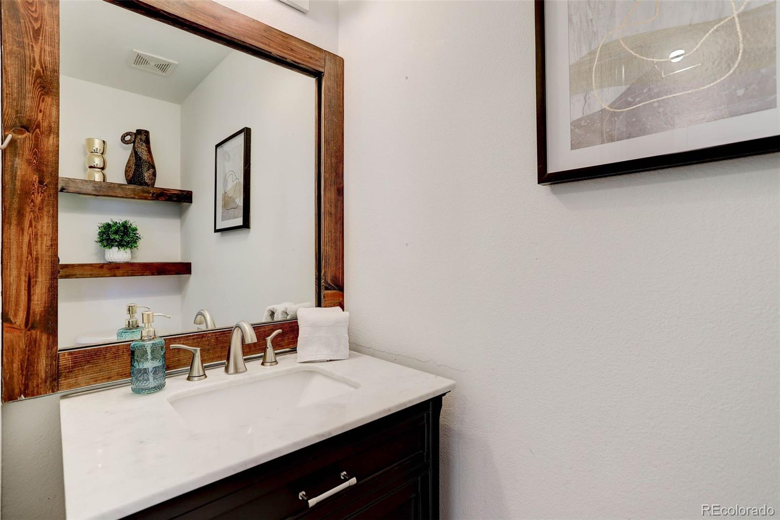 2471 South Andes Circle Aurora, CO 80013 - Photo 6 of 35 a room with a sink and a mirror