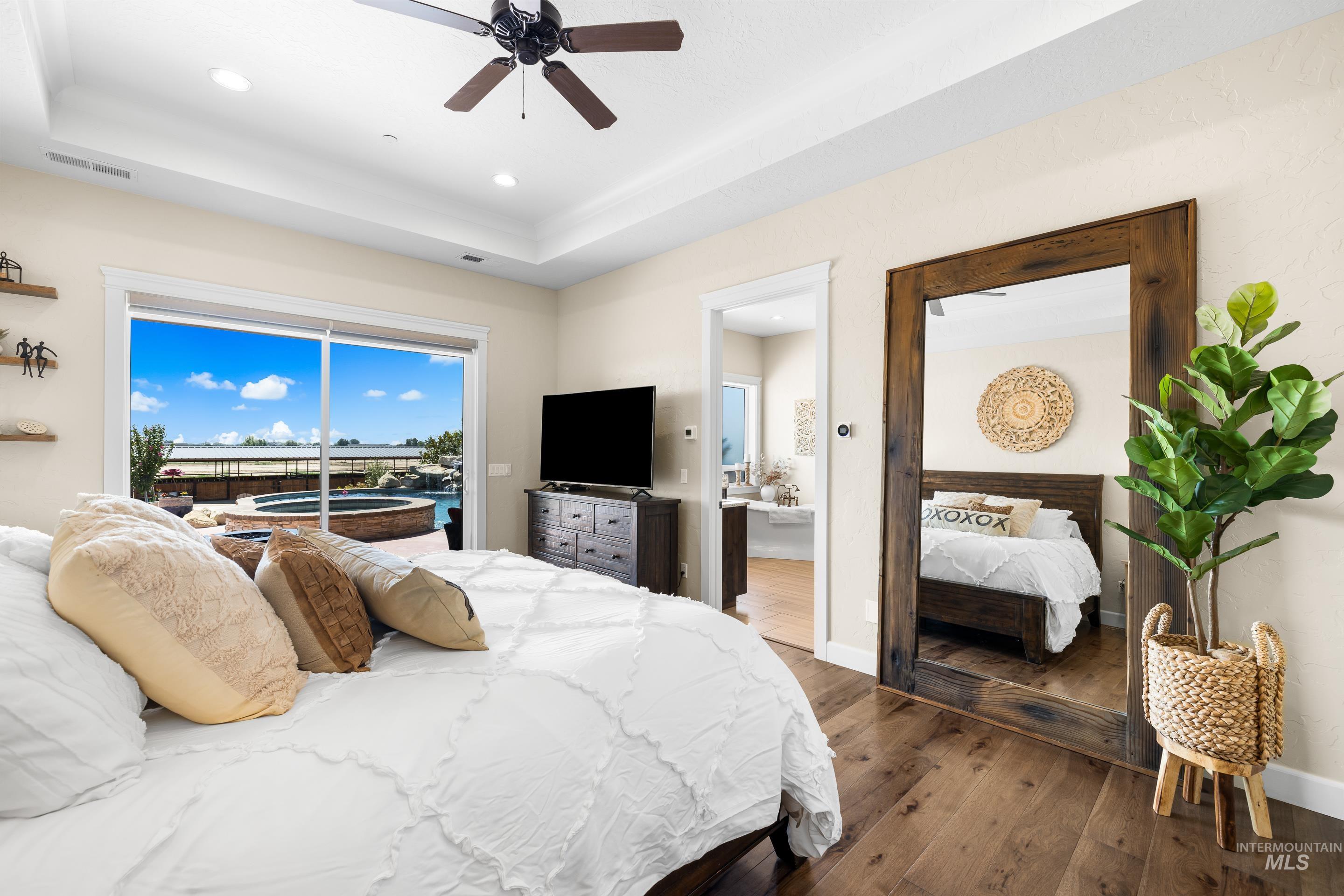 9819 Foothill Road Middleton, ID 83644 - Photo 25 of 50 Bedroom featuring hardwood / wood-style flooring, a raised ceiling, access to outside, recessed lighting, and a ceiling fan